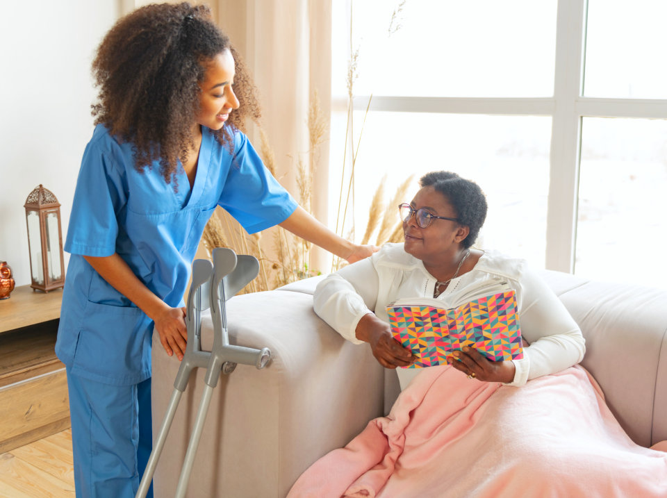 elderly woman talking to her female caregiver