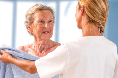 woman helped old woman in bath