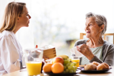 woman and old woman talking in dining area