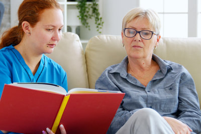 woman read something and old moman watching
