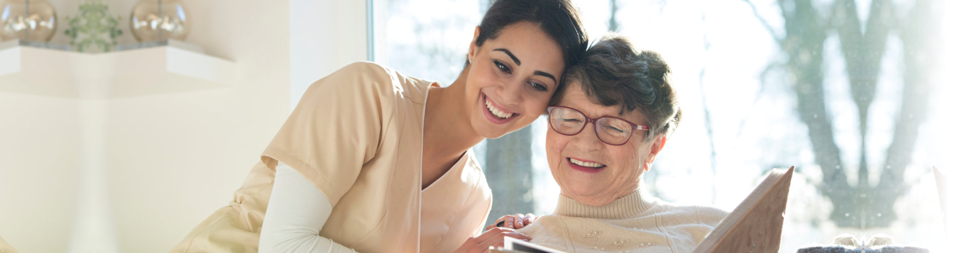 elderly woman with her caregiver smiling
