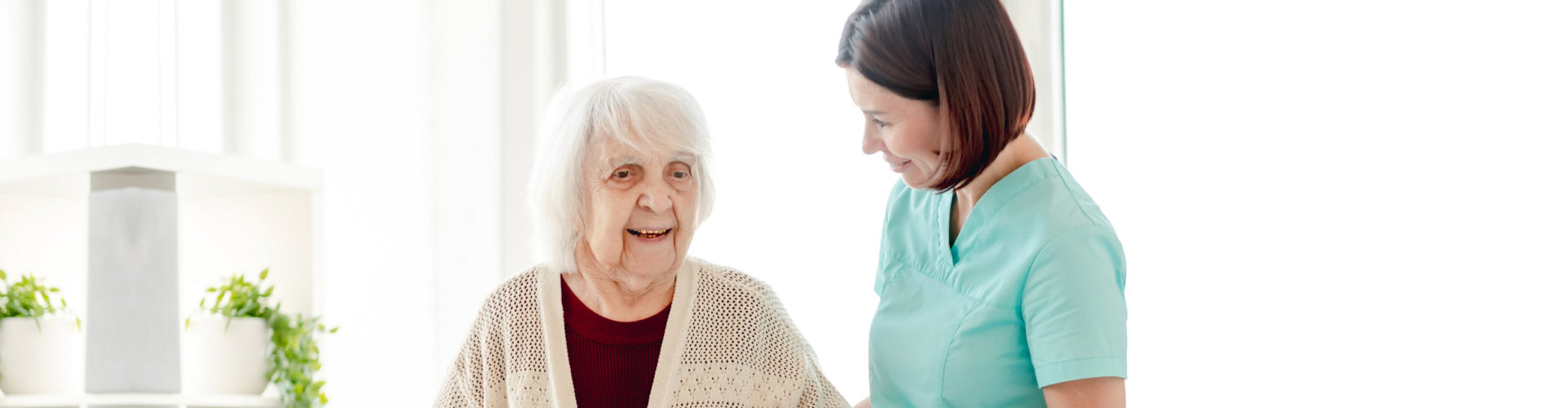elderly woman in the lobby with her caregiver